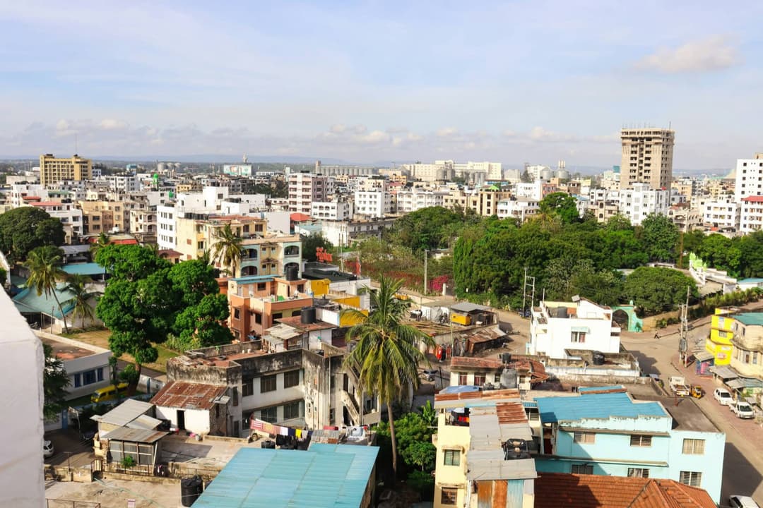 A coastal African city skyline under a blue sky